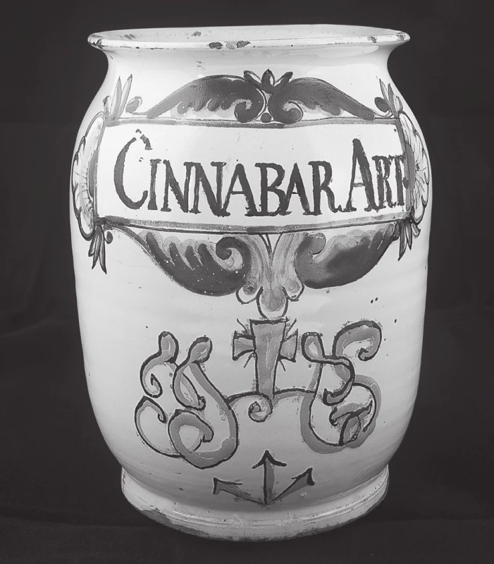Válcová stojatka s motivem IHS a nápisem „Cinnabar Art“