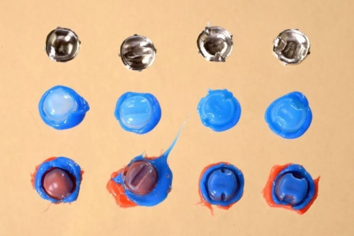 Milled crowns for tested preparation designs with replicas before sectioning (from left to right: standard preparation (SP), preparation with occlusal isthmus (OP), preparation with buccal/ lingual grooves (GP) and preparation with proximal boxes (BP)